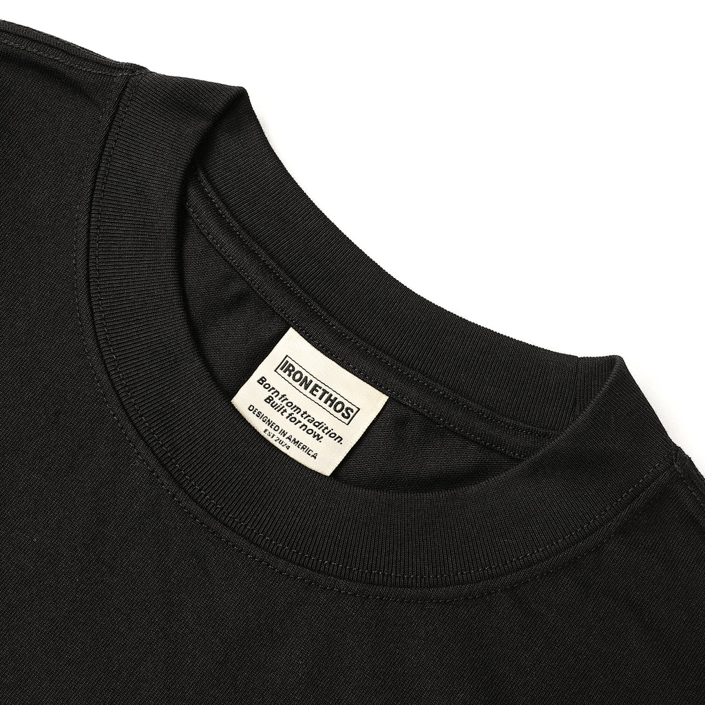 Iron Ethos Wordmark Tee, black short-sleeve T-shirt, close-up of the neckline.
